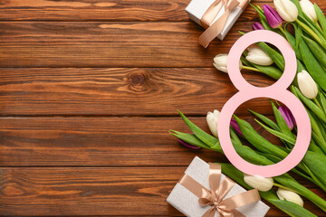 Figure 8 with gift boxes and beautiful tulips on wooden background. International Women's Day