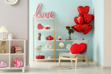 Interior of festive living room with grey armchair and decorations for Valentine's Day celebration