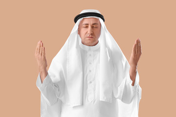 Muslim man praying on beige background