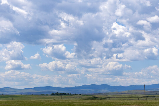 Beautiful nature landscape of rolling hills and open prairie with a dramatic cloudscape.