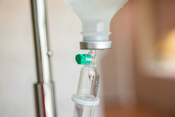 Close up medical intravenous IV drip in hospital background