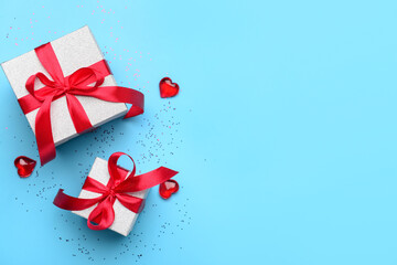 Composition with gift boxes and hearts for Valentine's Day celebration on blue background