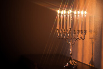 Hanukkah menorah, or hanukkiah in the light of the sun at sunset for Jewish holiday Hanukkah....