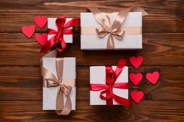 Composition with different gift boxes and hearts for Valentine's Day celebration on wooden background