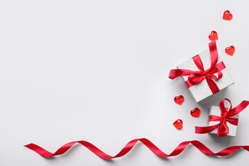 Composition with gift boxes, hearts and ribbon for Valentine's Day celebration on white background