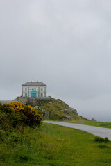 Image of a vintage house on a cloudy day with fog.