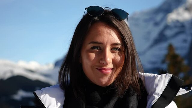 Brunette with sunglasses change facial expression from serious to smiling