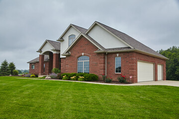 Fototapeta na wymiar Elegant Suburban Red Brick Home with Landscaped Lawn, Eye-Level View