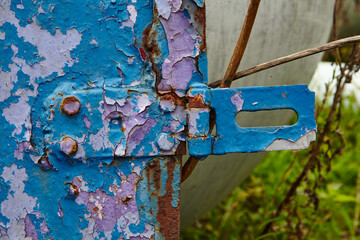 Rusty Metal Latch on Blue Peeling Paint, Eye-Level View