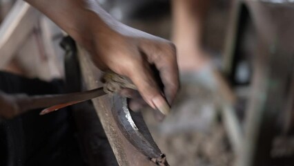 someone's hand was sanding a knife