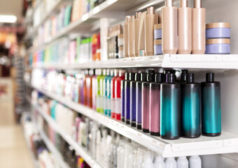 Colorful showcase in cosmetic shop with variety of hair care treatments, selective focus
