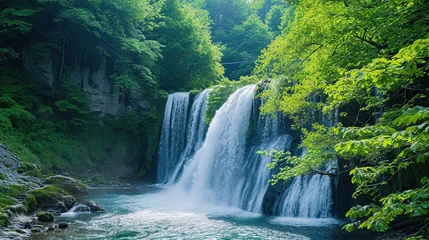 Raamstickers waterfall on the slopes of the mountains © saka