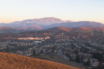 The golden light of the rising winter sun shines on Mt Diablo and foothills