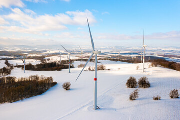 Aerial view of a wind turbine park in the winter field as a hub of renewable energy production