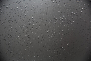 Raindrops of rain on the cold window.