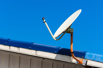 satellite dish on the roof with Blue sky background, for communication network or television technology