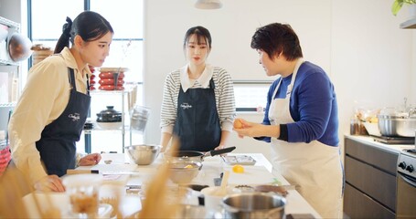 Japan, chef and cooking in kitchen with teaching for recipe, Japanese cuisine and healthy meal in...