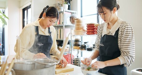 Cooking class, restaurant and women with Japanese food in a kitchen with chef and learning professional skill. Student, education and Asian cuisine course with people together working on skills