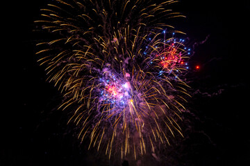 Holiday fireworks explode in the night sky. Selective focus. 