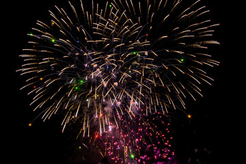 Holiday fireworks explode in the night sky. Selective focus. 