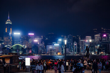 Panorama of Hong Kong City skyline with tourist at night. View from across Victoria Harbor HongKong.
