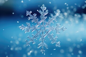 A close-up view of a snowflake on a vibrant blue background. Perfect for winter-themed designs and holiday projects