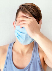 Sad Young Man in Flu Mask
