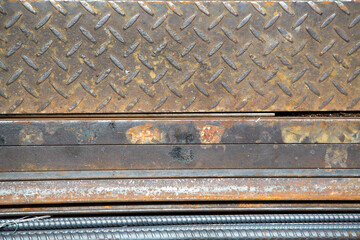 Weathered iron wall with seamless background of iron products