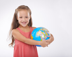Child, portrait and world globe for education school learning in studio for Geography, continents or white background. Girl, student and planet for class studying Earth population, travel or mockup