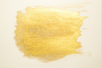 gold paint splatter on a white background
