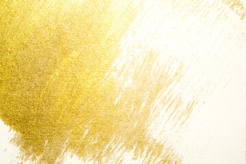 gold paint splatter on a white background