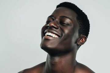 Obraz premium Joyful African Man Laughing with Closed Eyes on Light Background. Generative AI. 