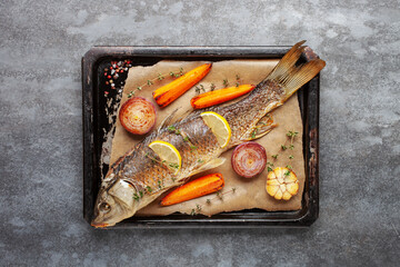 Fried carp whole. Served with lemon and roasted vegetables. Czech Traditional Christmas Food. Top...