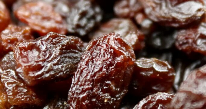 Extreme close up video of delicious raisins in rotating motion