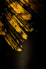 gold paint splatter on a black background
