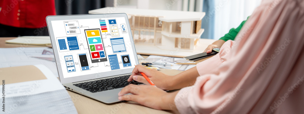 Poster cropped image of interior designer team presents color by using color swatches while laptop displaye