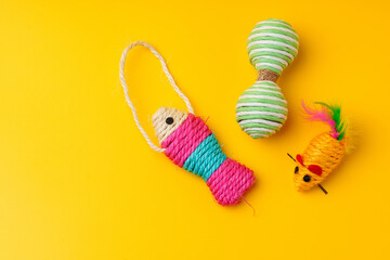 Pet toys on yellow background studio shot