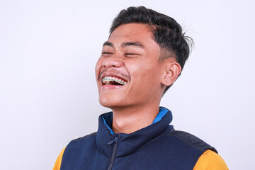 Close-up view of young boy Asian student with dental braces laughing  