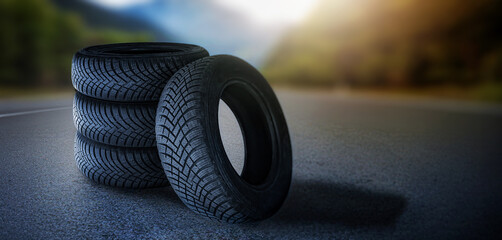 Four summer tire on road. Change tyre. 4 wheel off on nature in blurred background. Advertise...