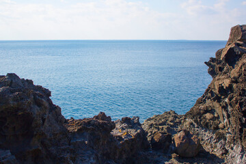 A landscape with basalt rocks and the sea.