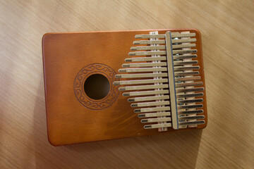 This is a kalimba placed on a wooden table.