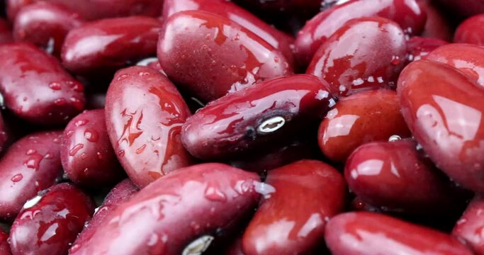 Extreme close up video of red-brown kidney beans in rotating motion