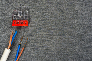 Various electrical terminal blocks, wiring connectors on the gray workbench flat lay background...