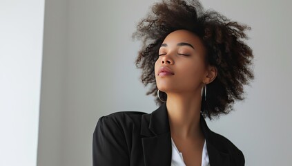 Young African American woman in black, closed eyes portrait. Inner peace concept.