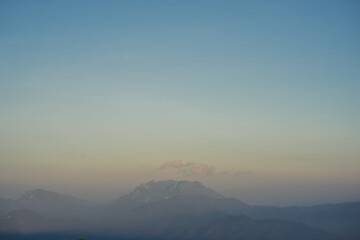 travel and people activity concept with twilight sky before sunset with layer of mountain