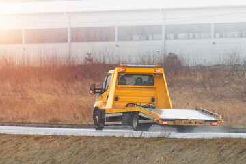 Empty tow truck on the public road highway. Concept of roadside assistance.
