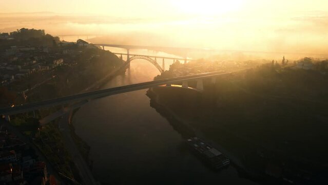 Dona Maria Pia railway bridge over Douro river at sunset, arial view above  Porto, Portugal