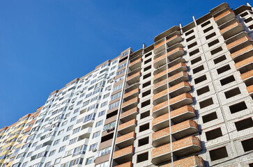 New concrete building under construction with brick work. Construction site