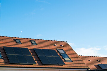 Solar panels are seen on the roof on a new residencial Irish house on a sunny day.