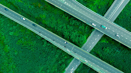 Cars on forest roads and elevated traffic intersections, modern road design travel concept for the...